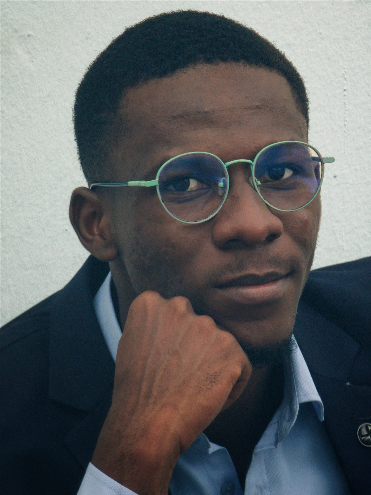 Portrait of Dr. Tolulope Ajidahun, chin resting on hand